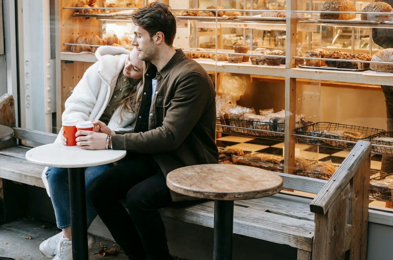 Young couple having rest in small cafeteria