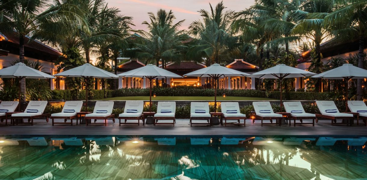 brown and white wooden house near swimming pool during daytime